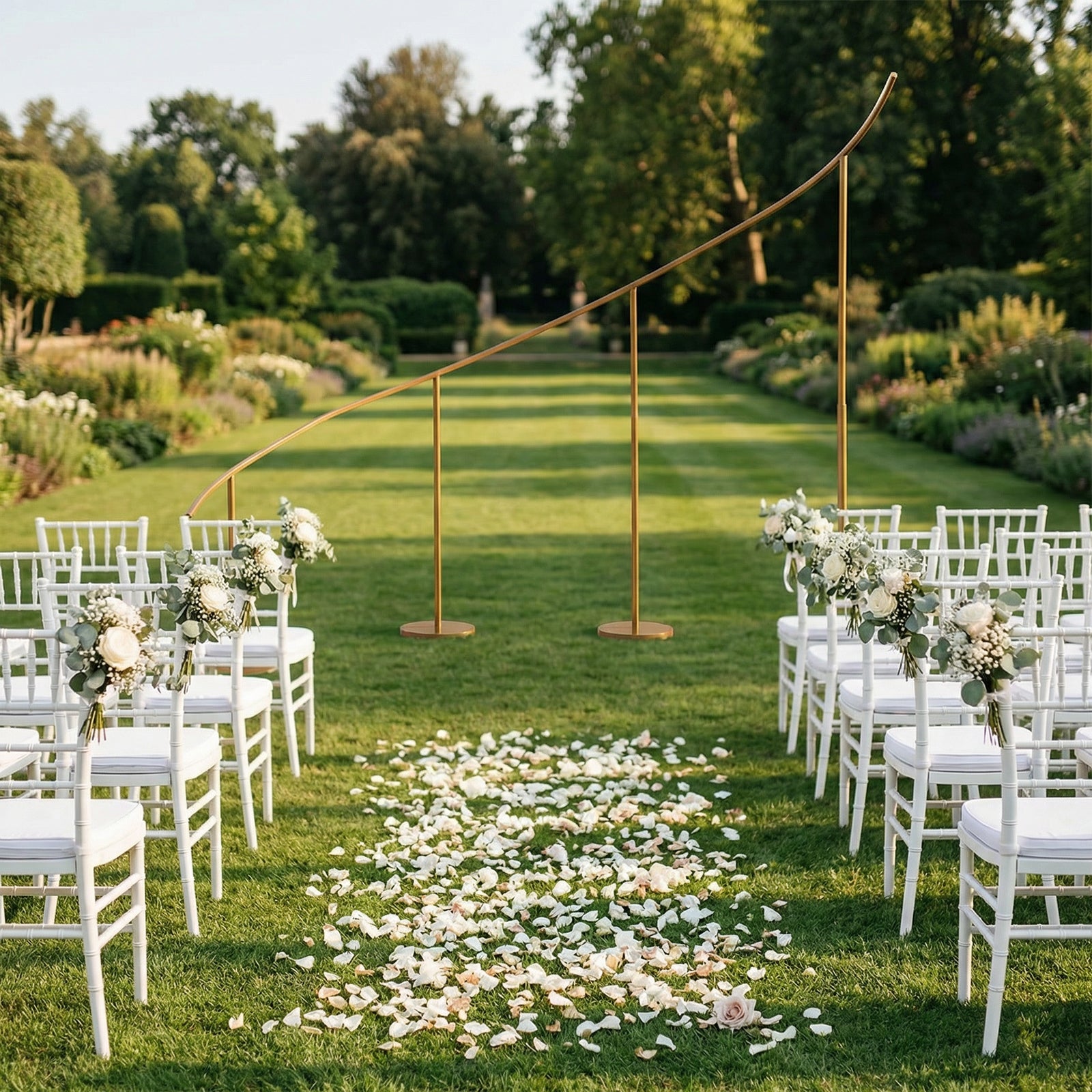 Gold curved wedding arch backdrop stand in a garden setting.