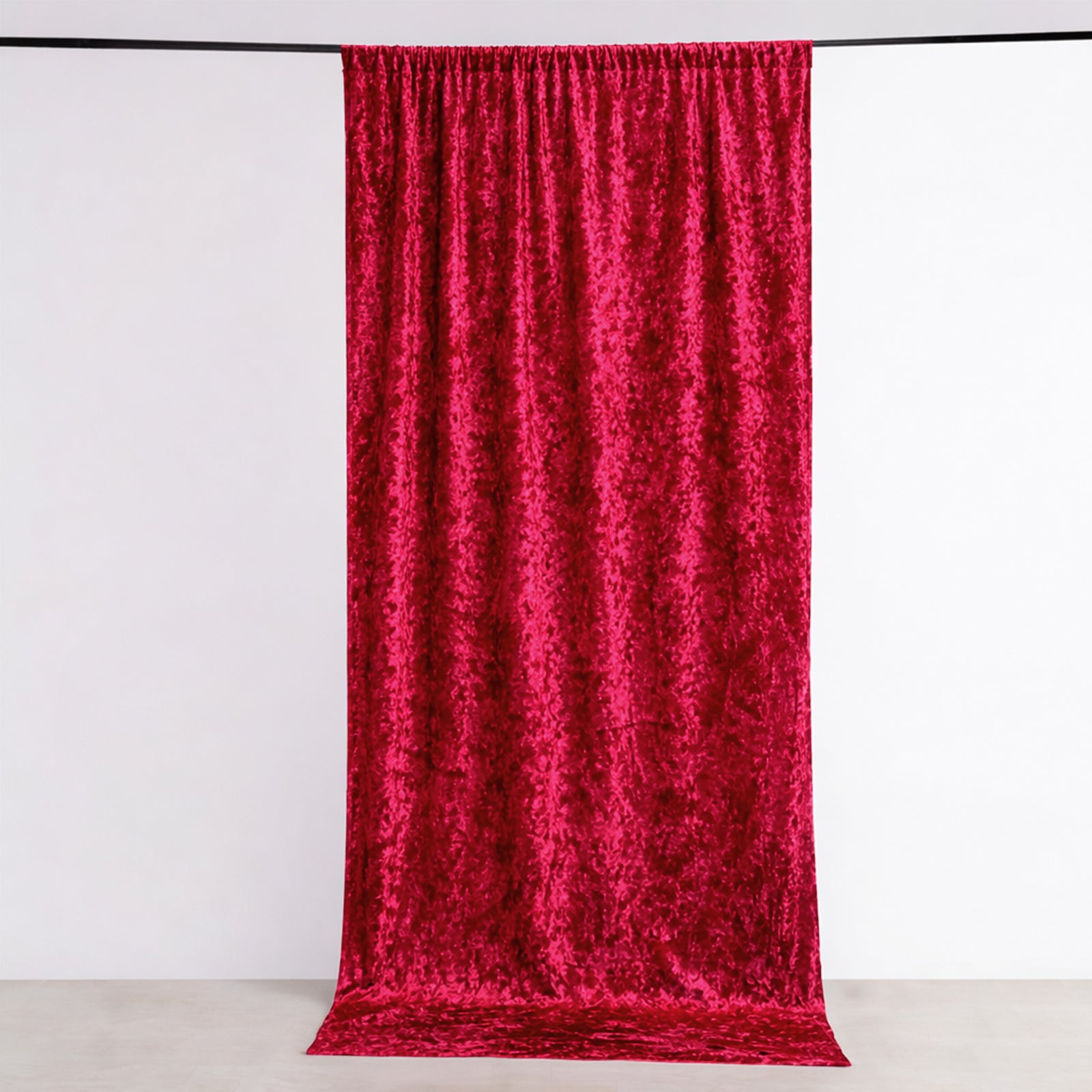 Red crushed velvet backdrop curtain for events and photo booths.