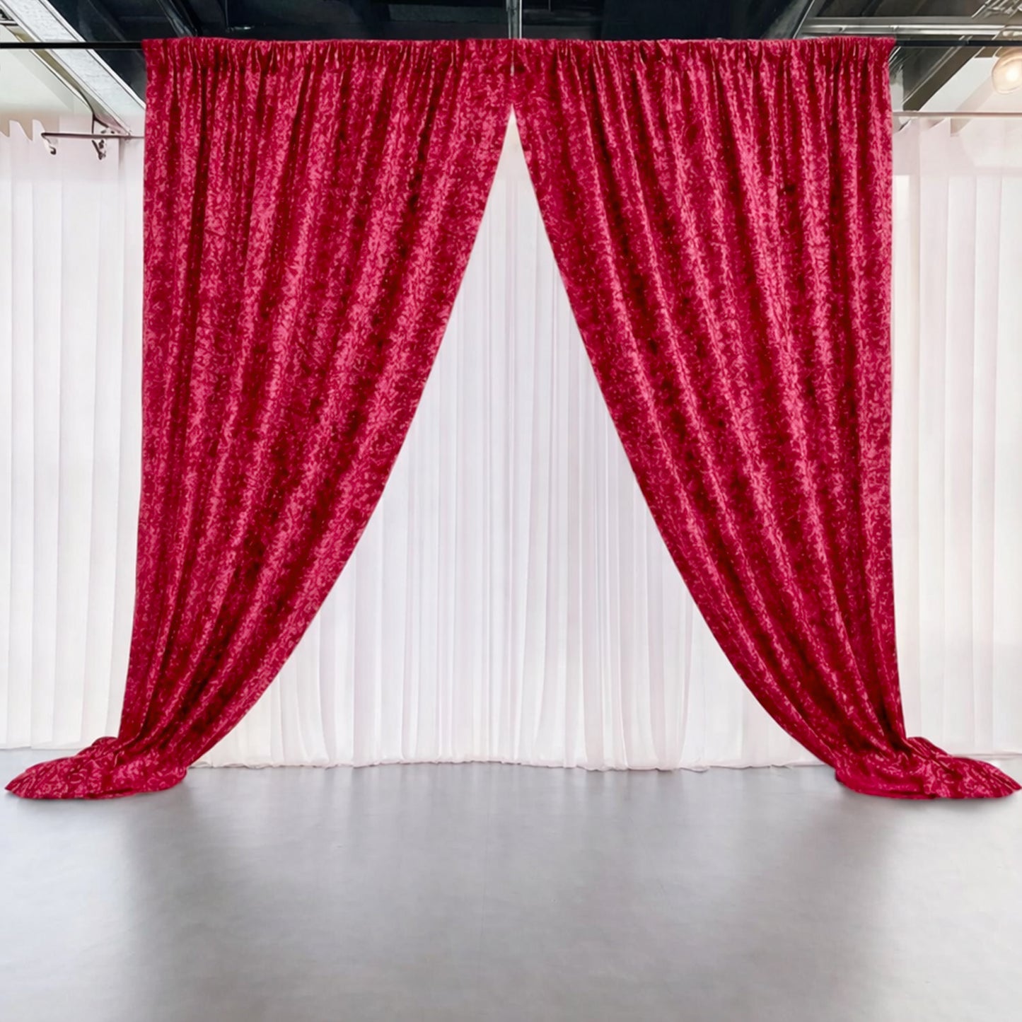 Red crushed velvet backdrop curtain for events and photo booths.