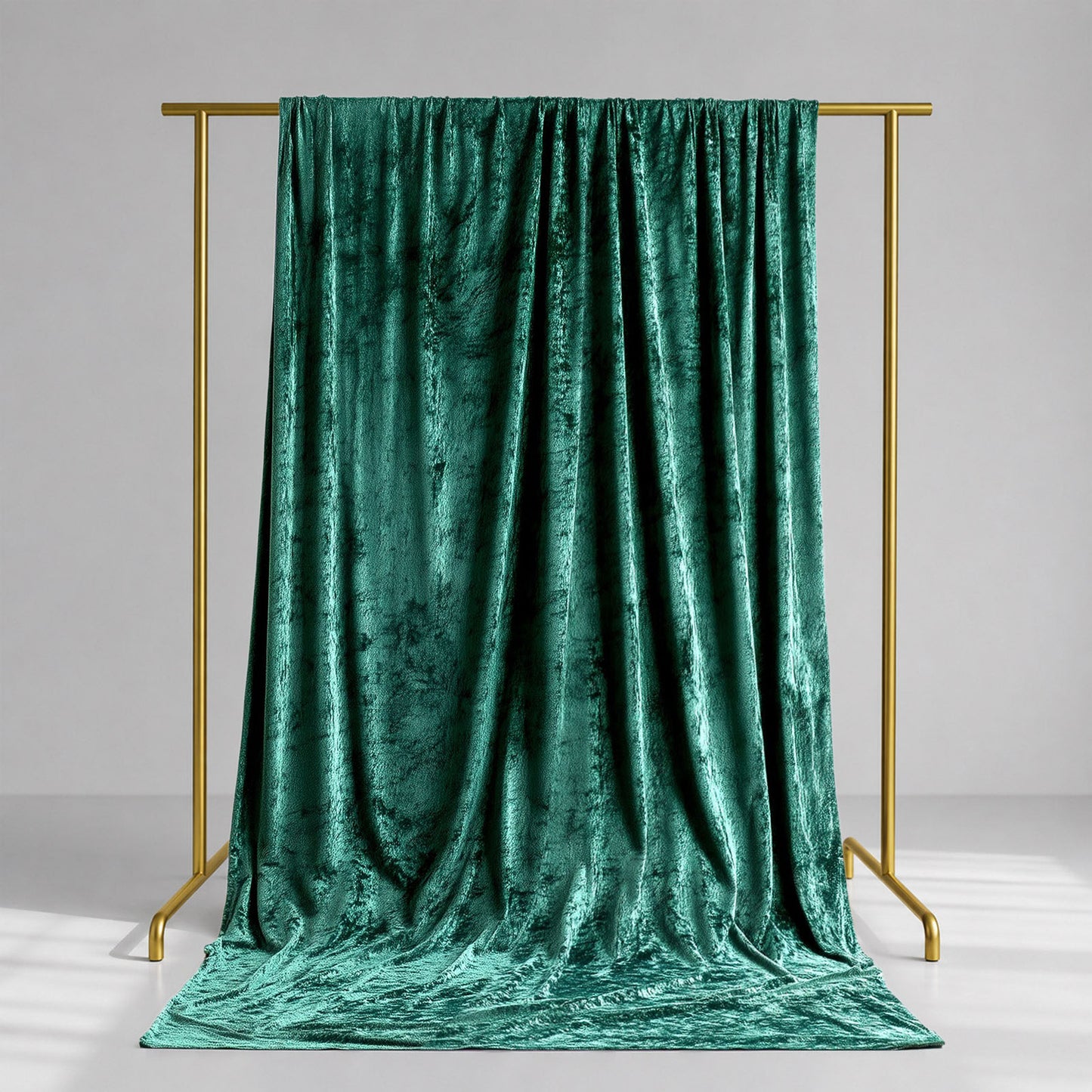 Emerald green crushed velvet backdrop curtain for events and photo booths.