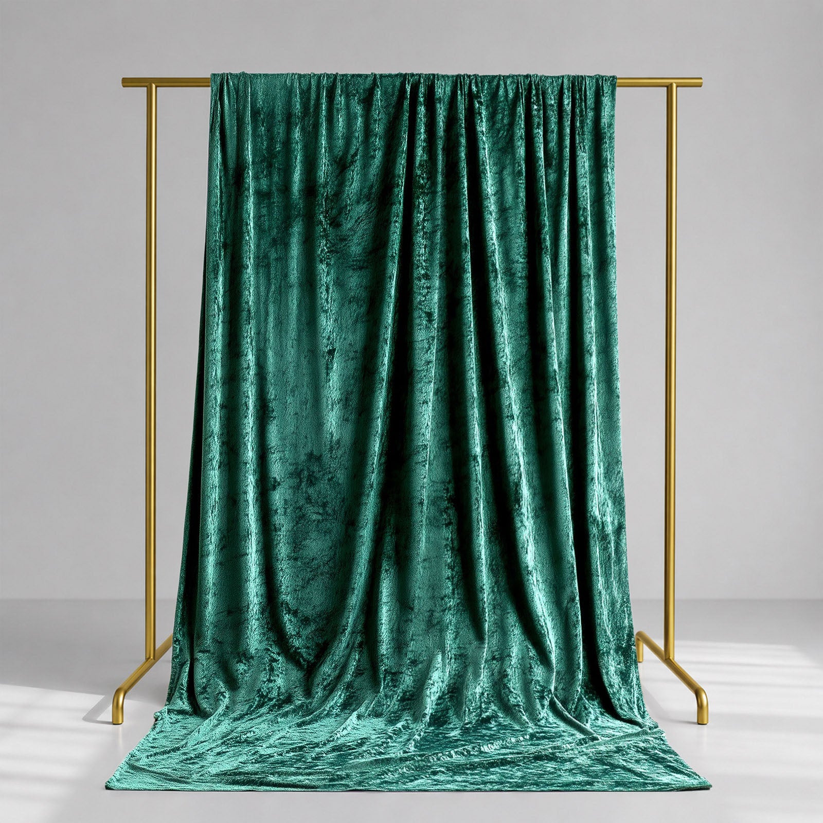 Emerald green crushed velvet backdrop curtain for events and photo booths.