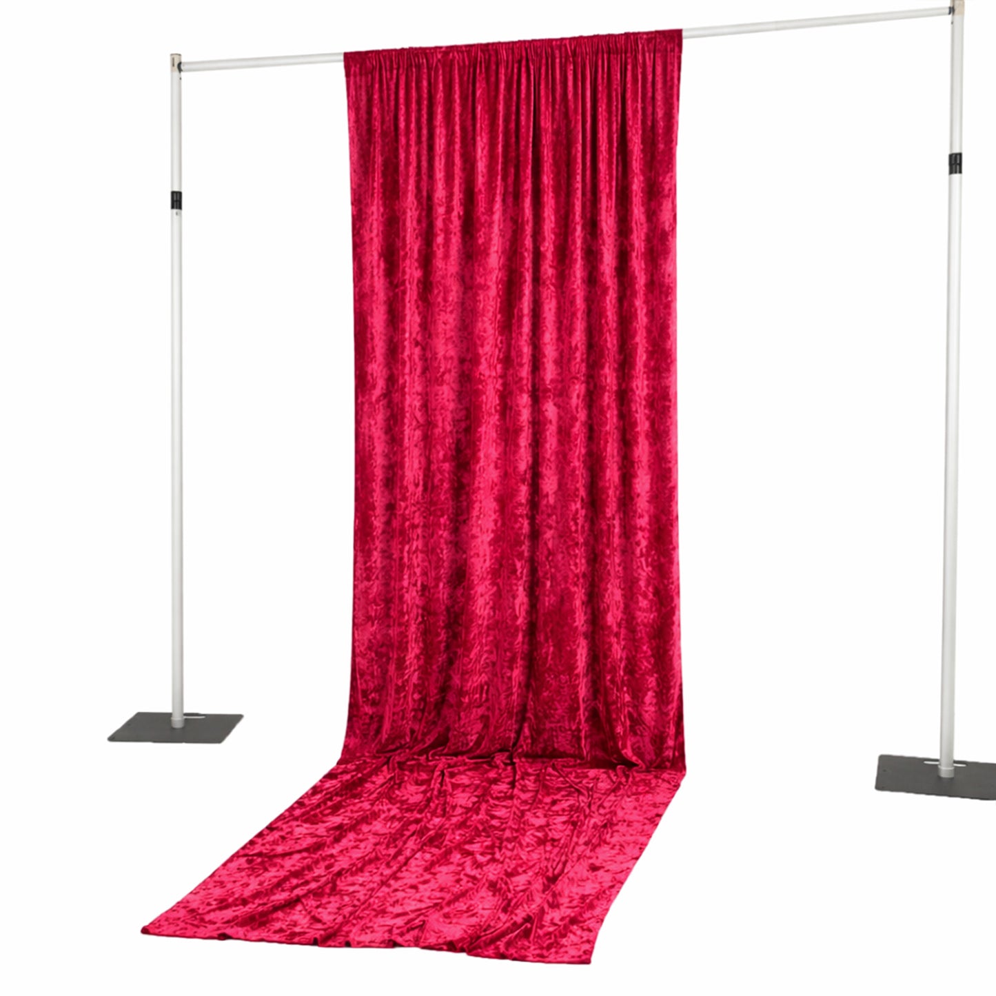 Red velvet backdrop draped on a stand for photography or event decor.