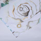 White rustic wood floral backdrop with a large rose design for birthday celebrations.