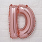 Rose gold Mylar foil letter balloon "D" in matte finish.