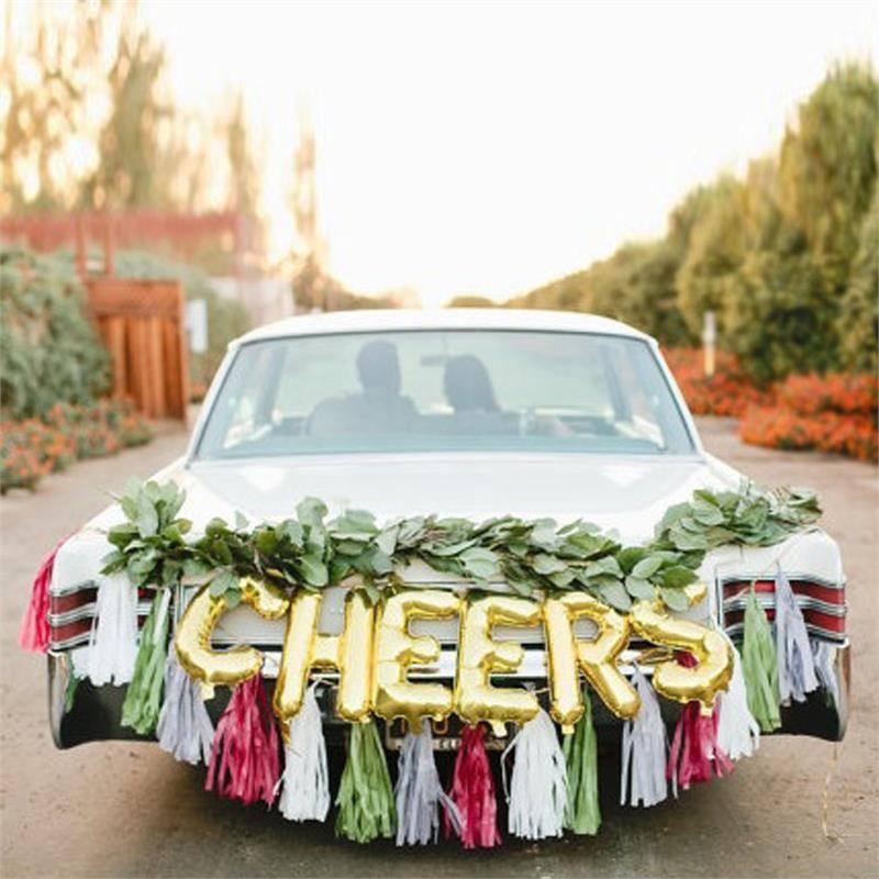 Matte gold letter and number balloons on a decorated car.