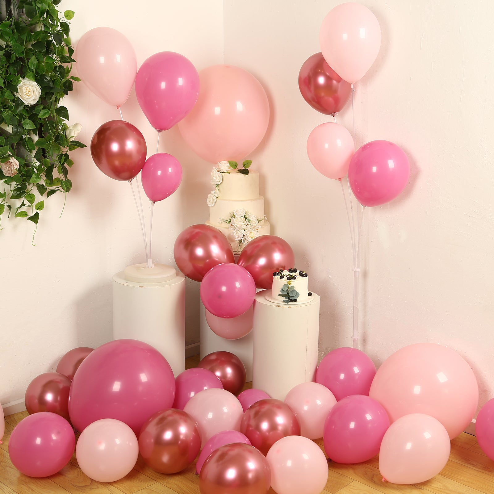 Rose gold pink biodegradable balloon arch kit in a festive party setup.