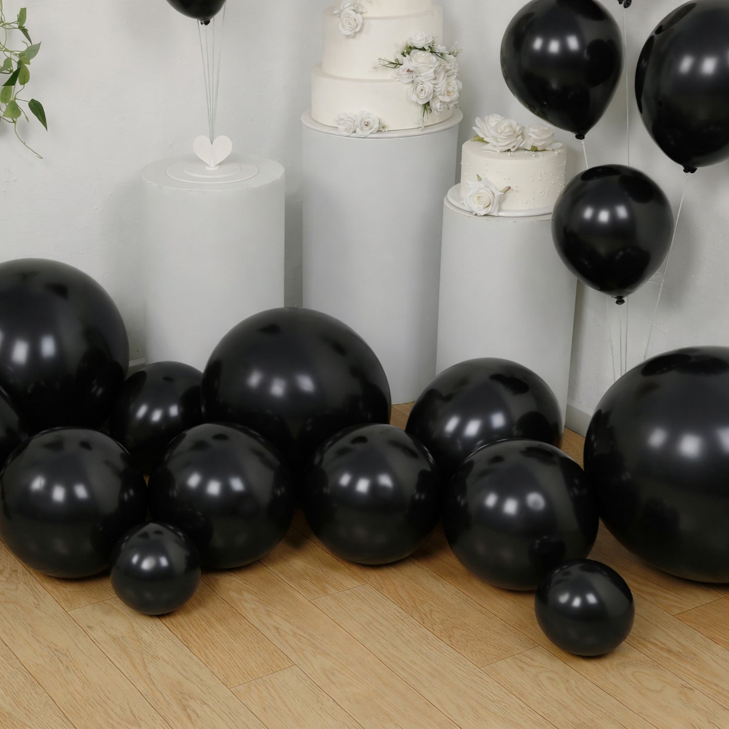 Black balloon garland kit for party decor, featuring biodegradable latex balloons.