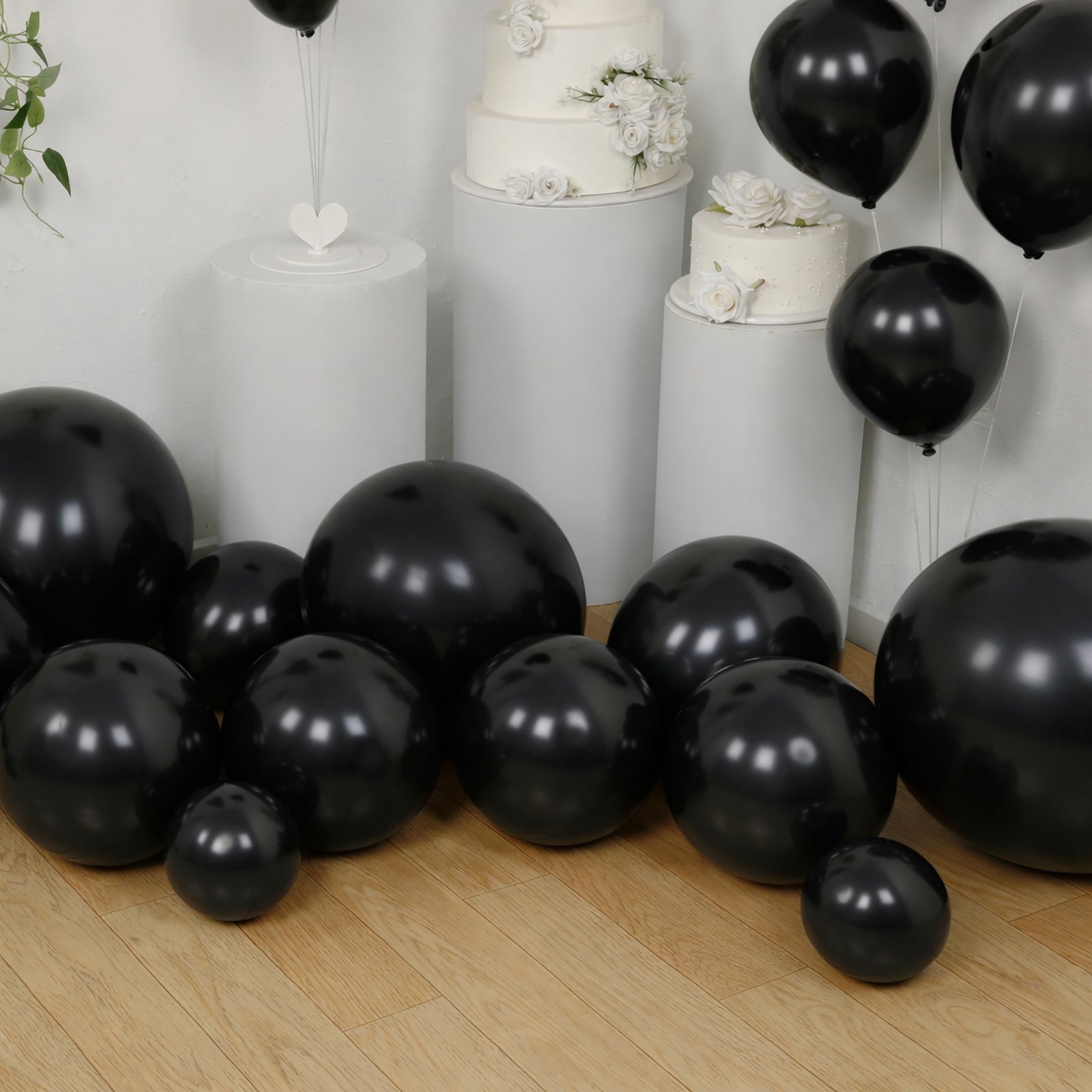 Black balloon garland kit for party decor, featuring biodegradable latex balloons.