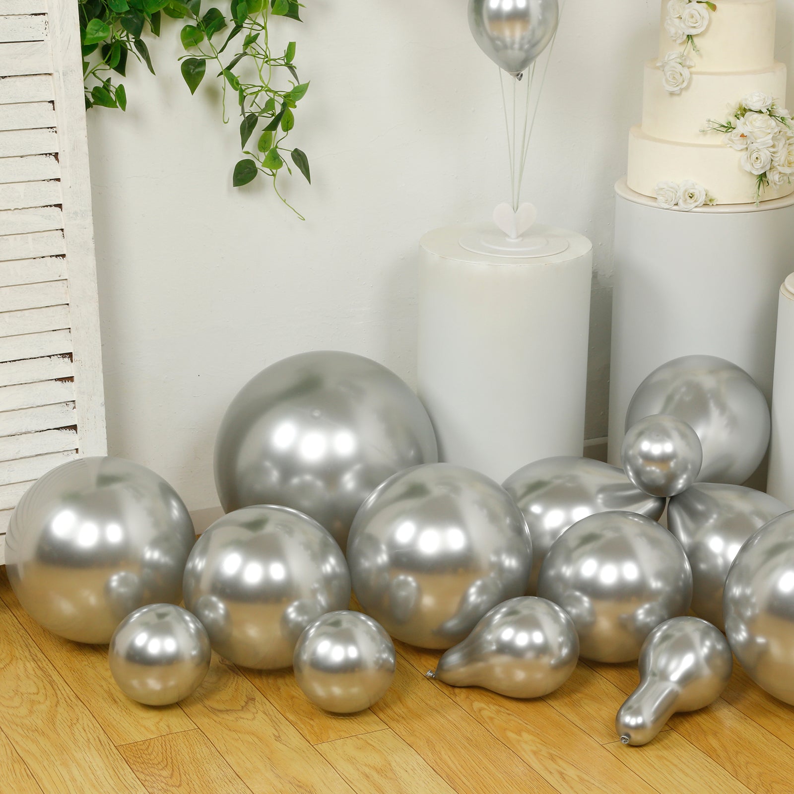 Silver balloon garland kit for party arch décor, featuring biodegradable latex balloons.