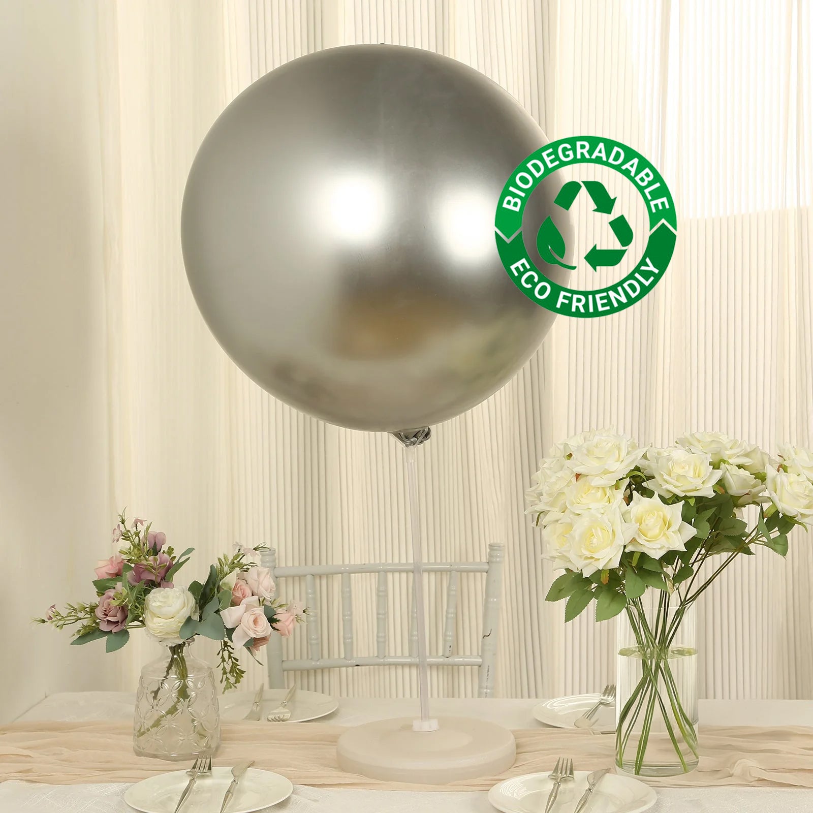 Metallic chrome silver biodegradable balloon in a festive setting.