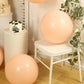 peach biodegradable balloons in a rustic setting
