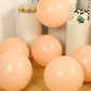Matte pastel blush biodegradable balloons in a festive setting.