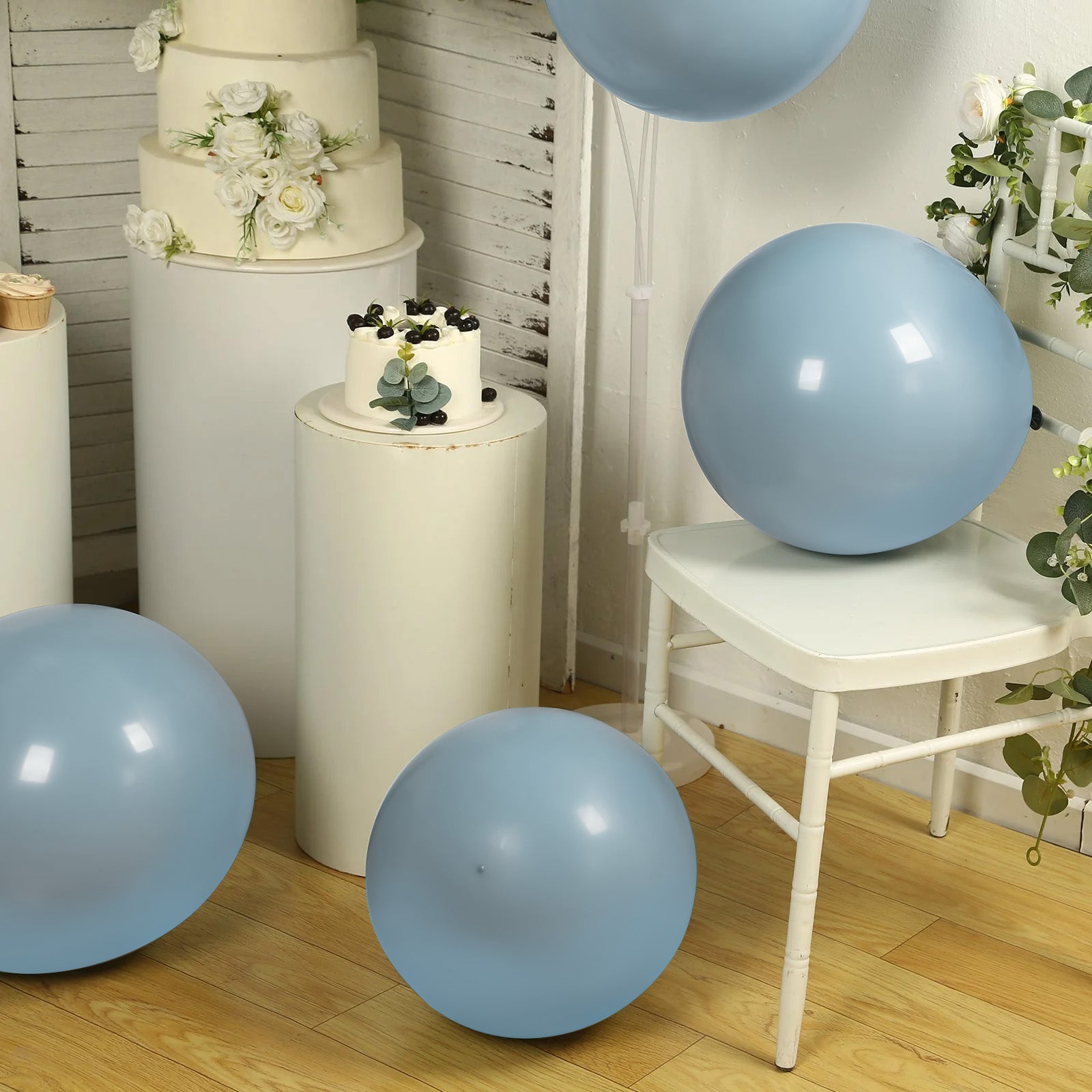 Matte pastel dusty blue biodegradable balloons in a festive setting.