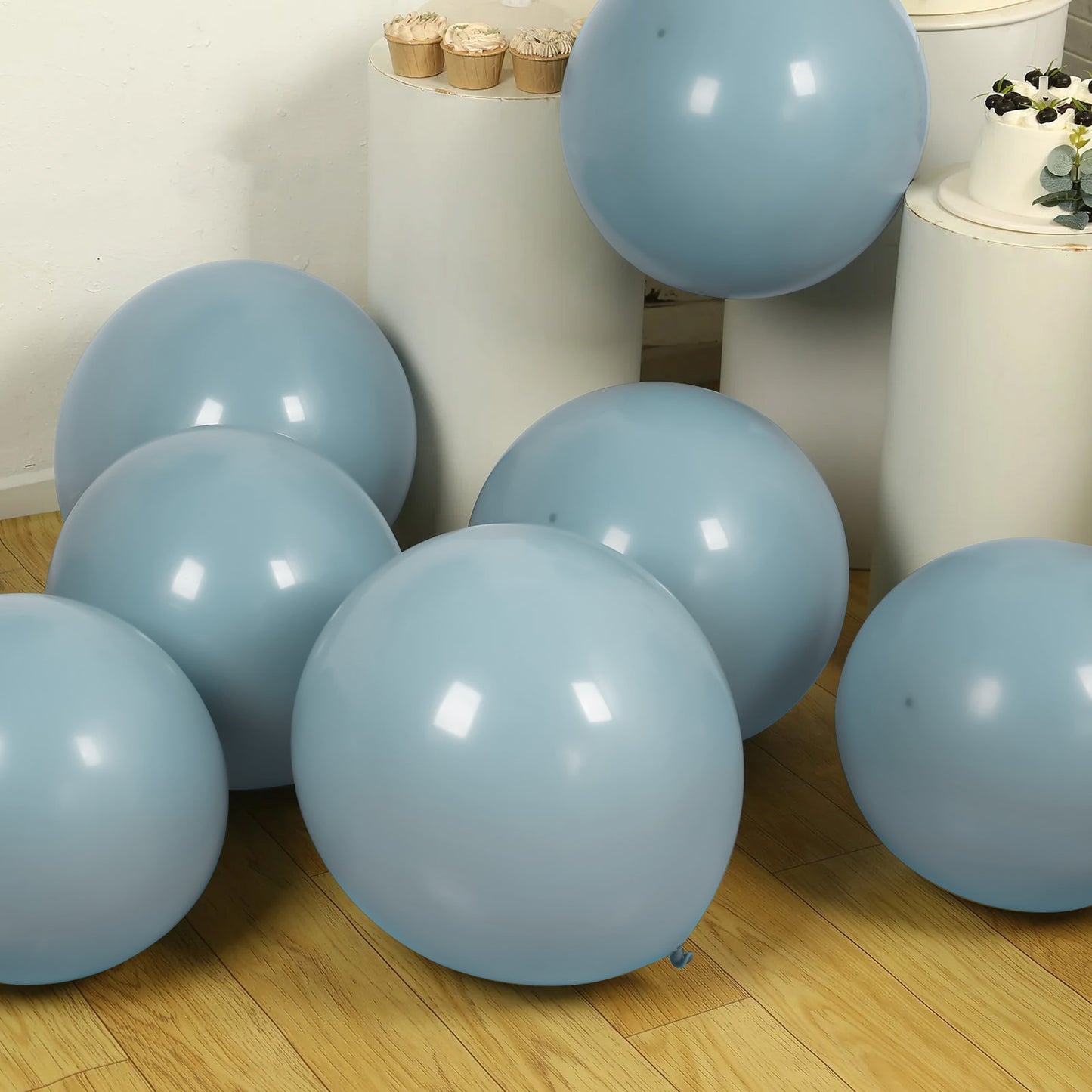 Matte pastel dusty blue biodegradable balloons in a stylish party setup.