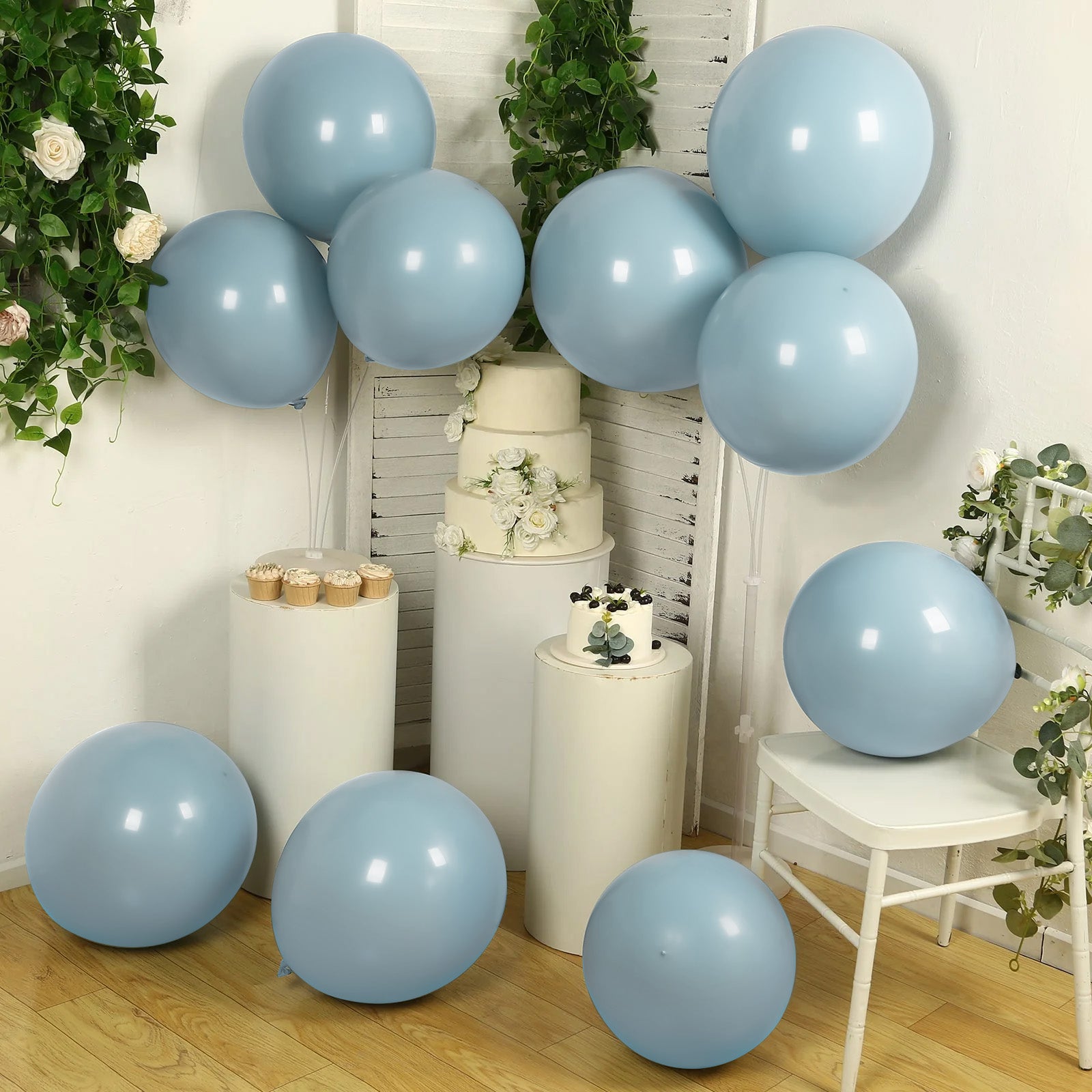 Matte pastel dusty blue biodegradable balloons in a party setting.