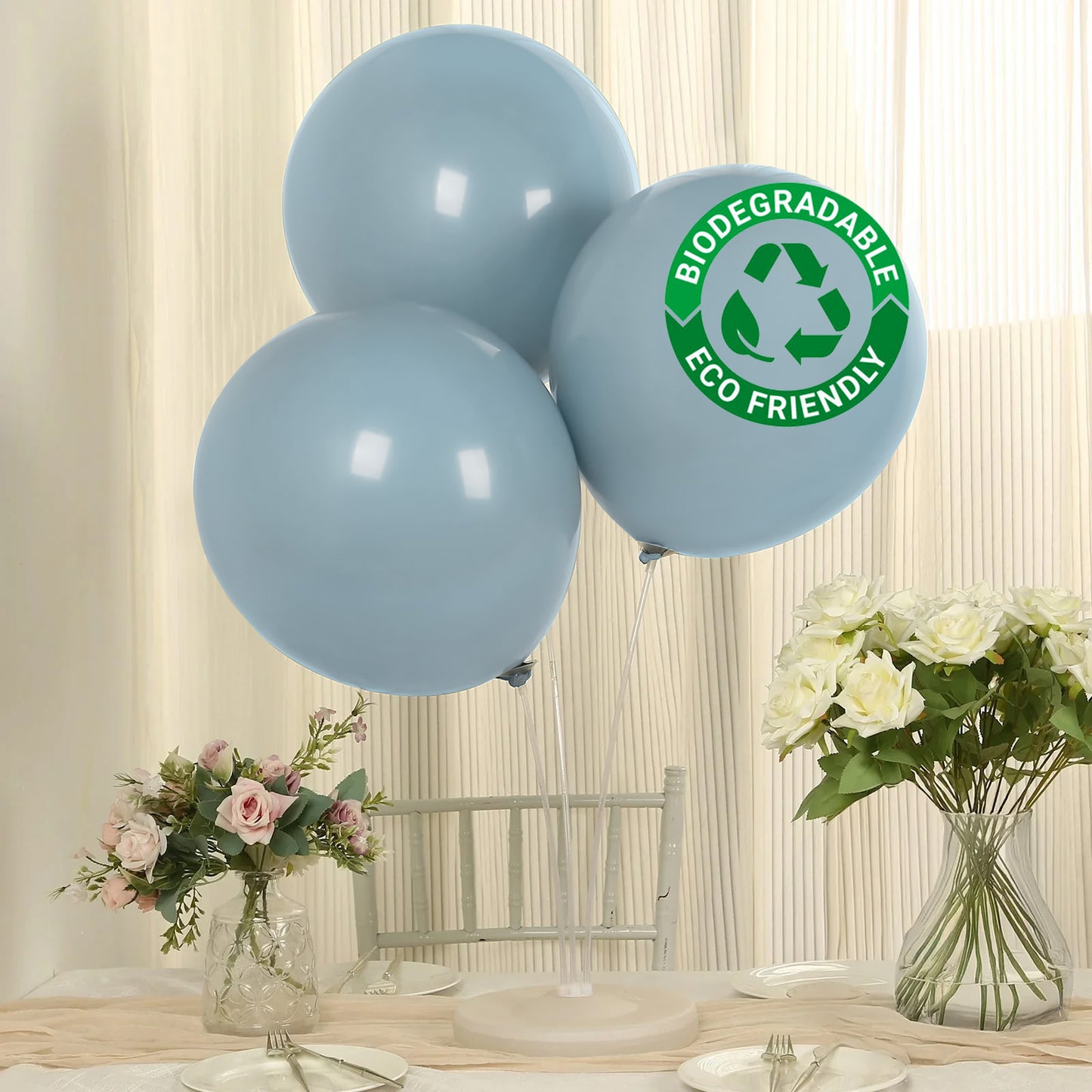 Matte pastel dusty blue biodegradable balloons on a table.