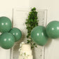 Matte pastel dusty sage green biodegradable balloons arranged decoratively.