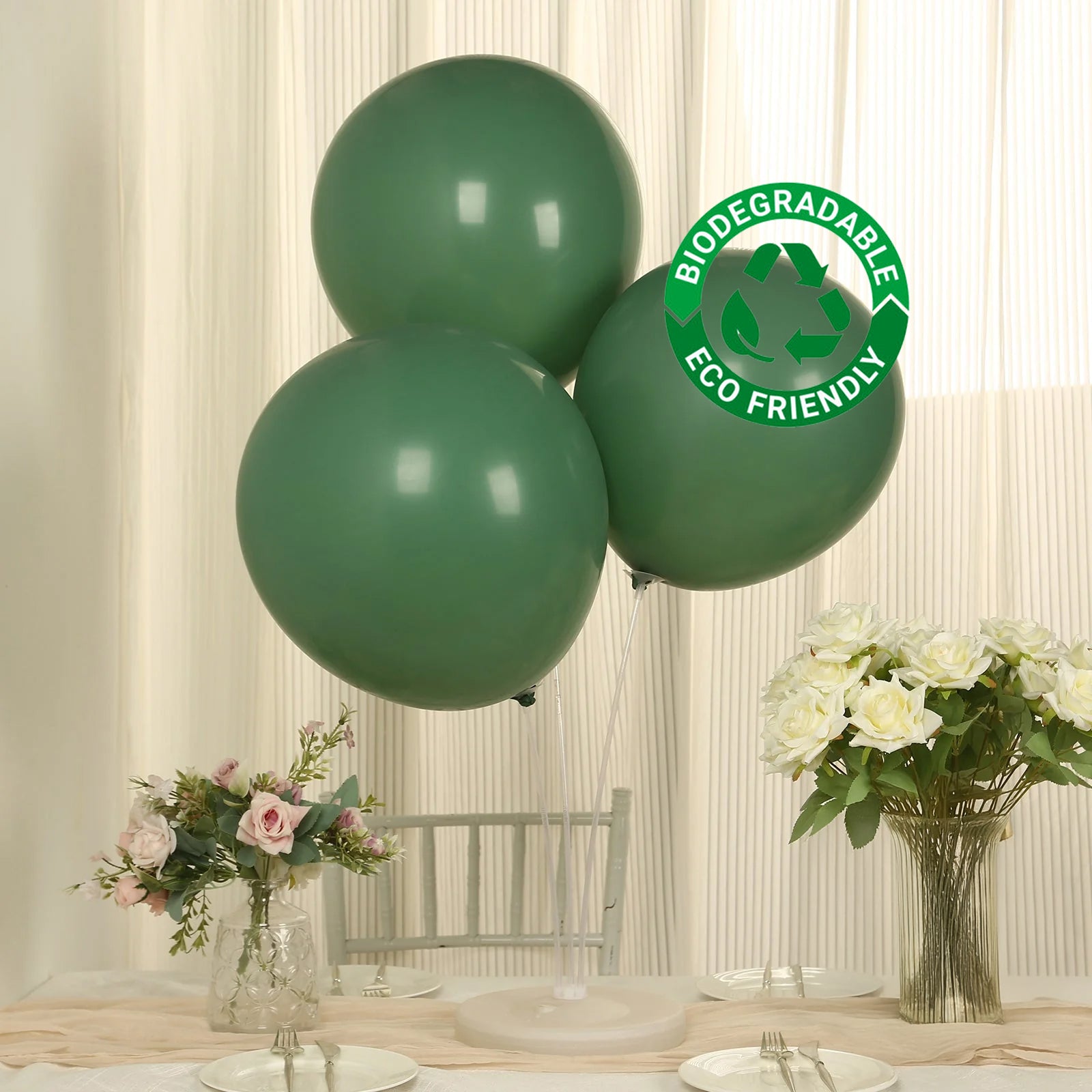 Matte pastel dusty sage green biodegradable balloons on a table setting.