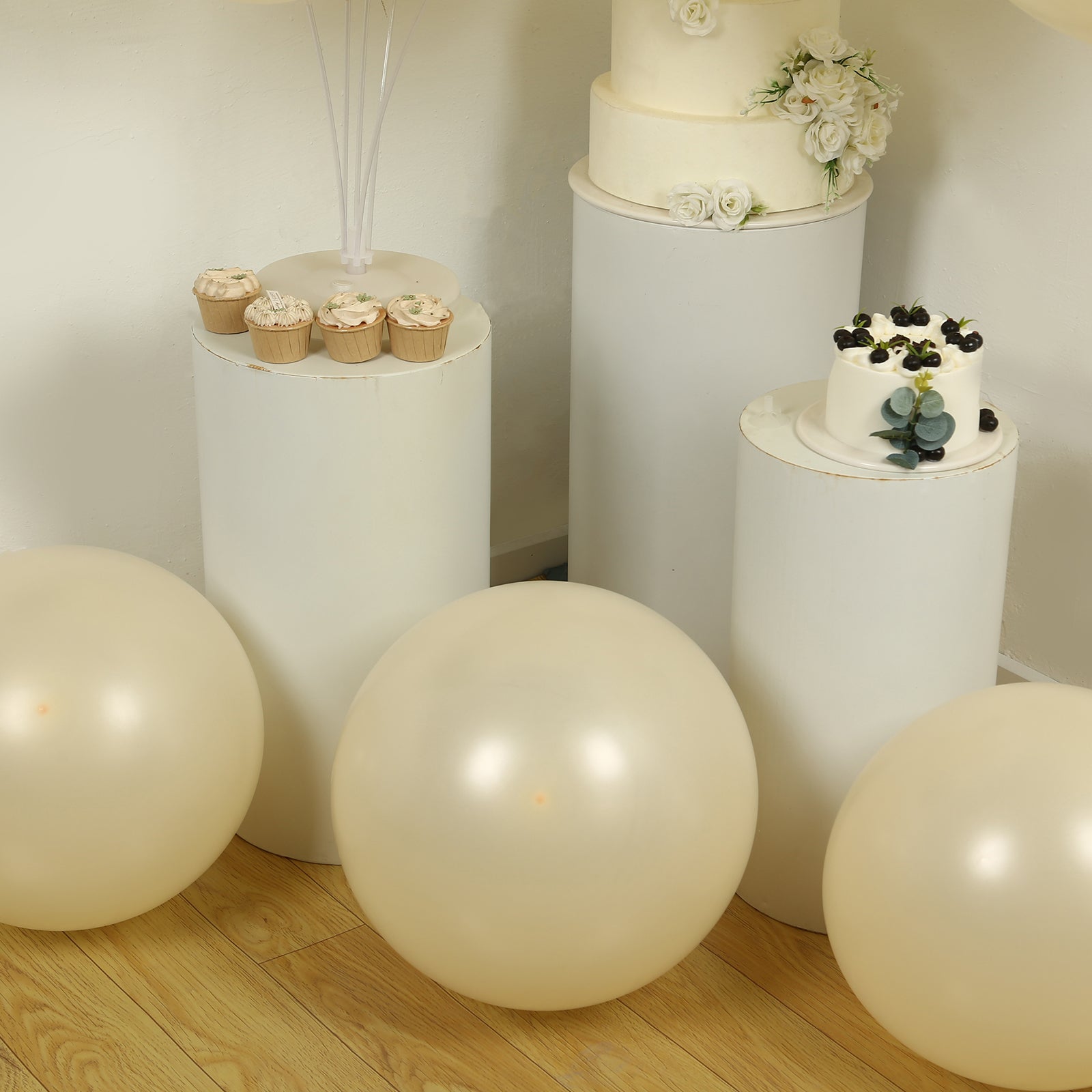 Matte pastel cream biodegradable balloons on display with decorative cakes.