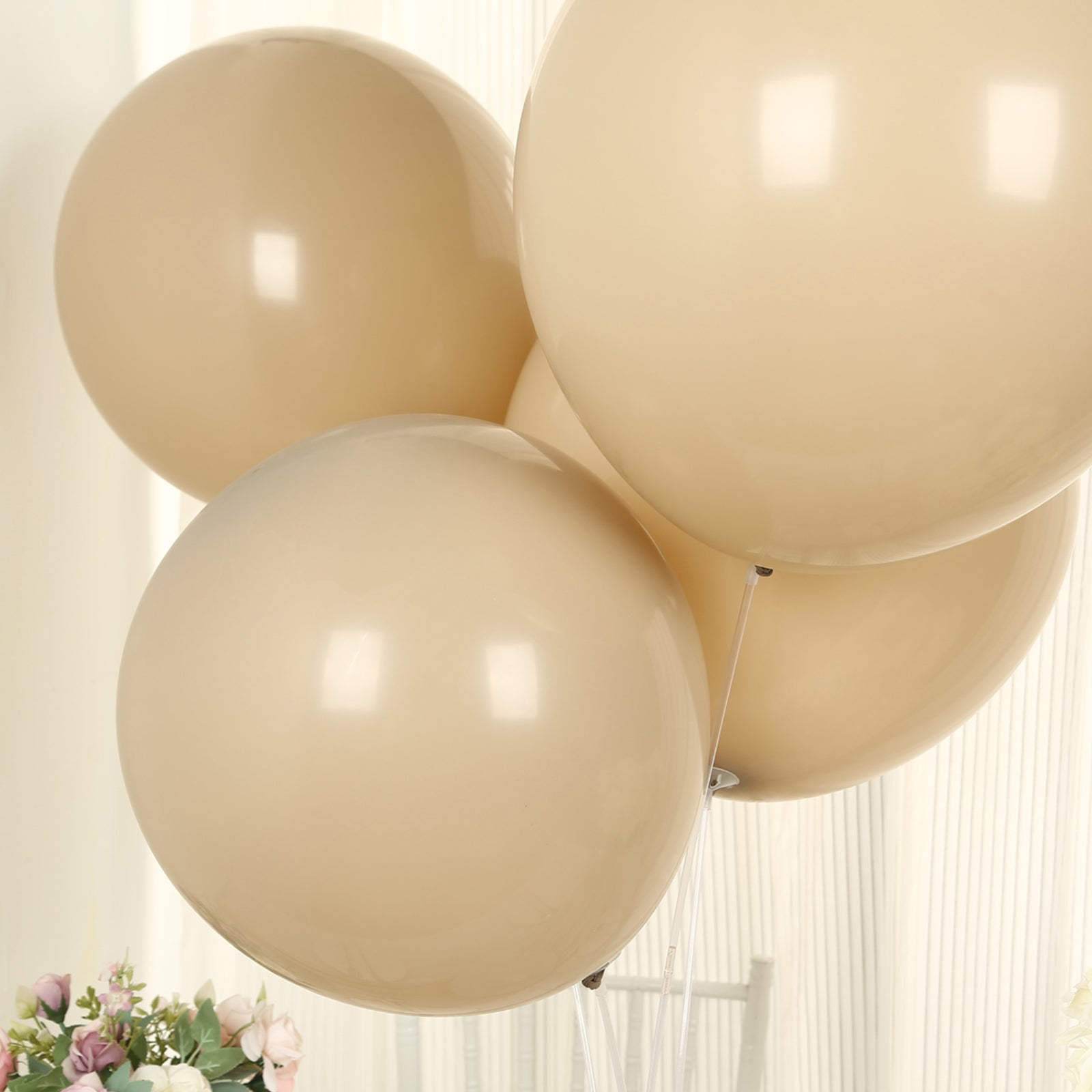 Matte pastel taupe biodegradable balloons in a party setting.