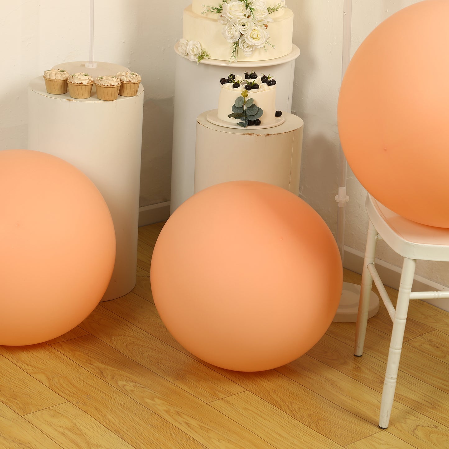 Large matte pastel blush biodegradable balloons in a festive setting.