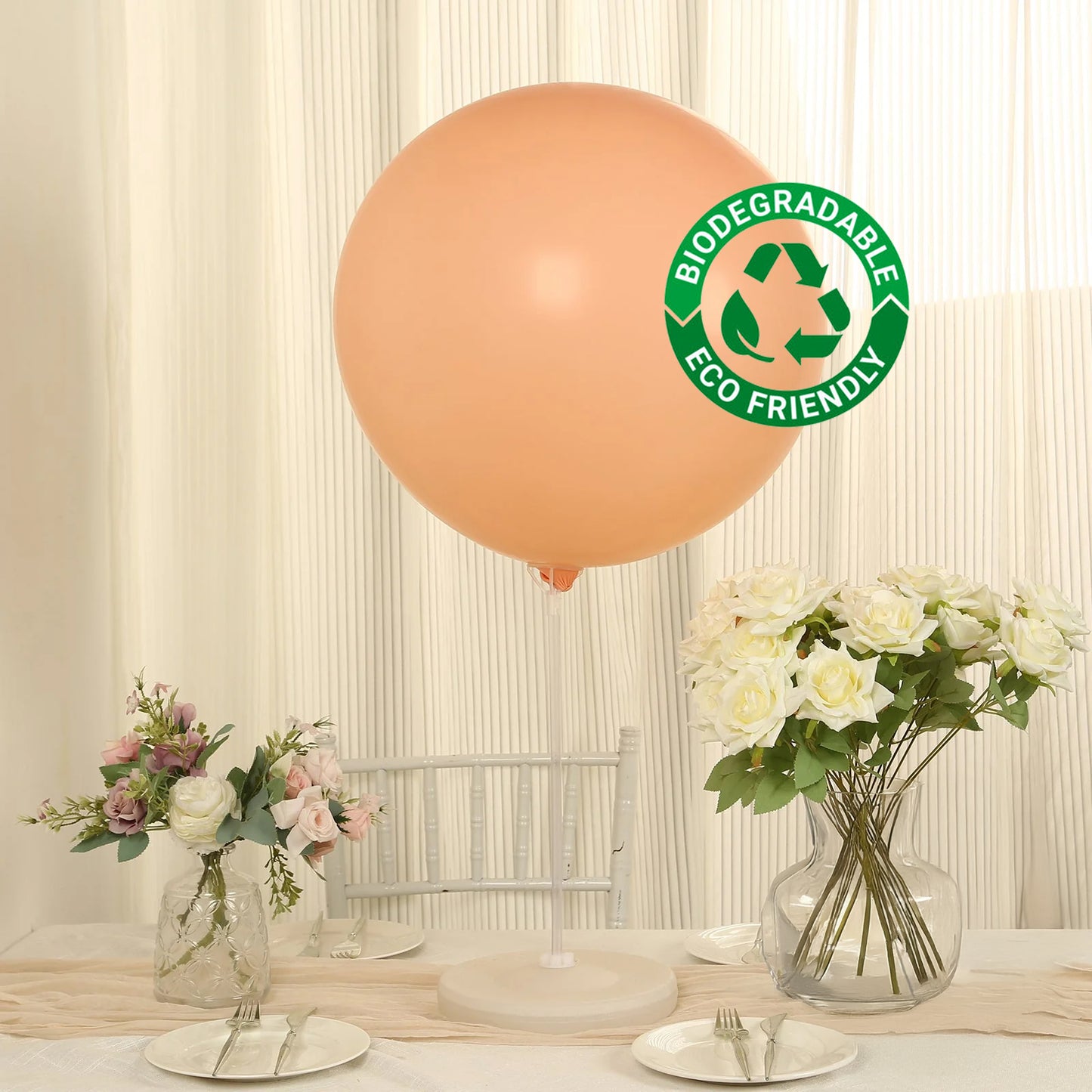 Large matte pastel blush biodegradable balloon in a bright setting.