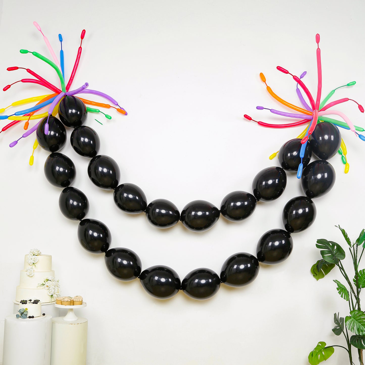 Matte pastel black biodegradable linking balloons in a decorative garland.