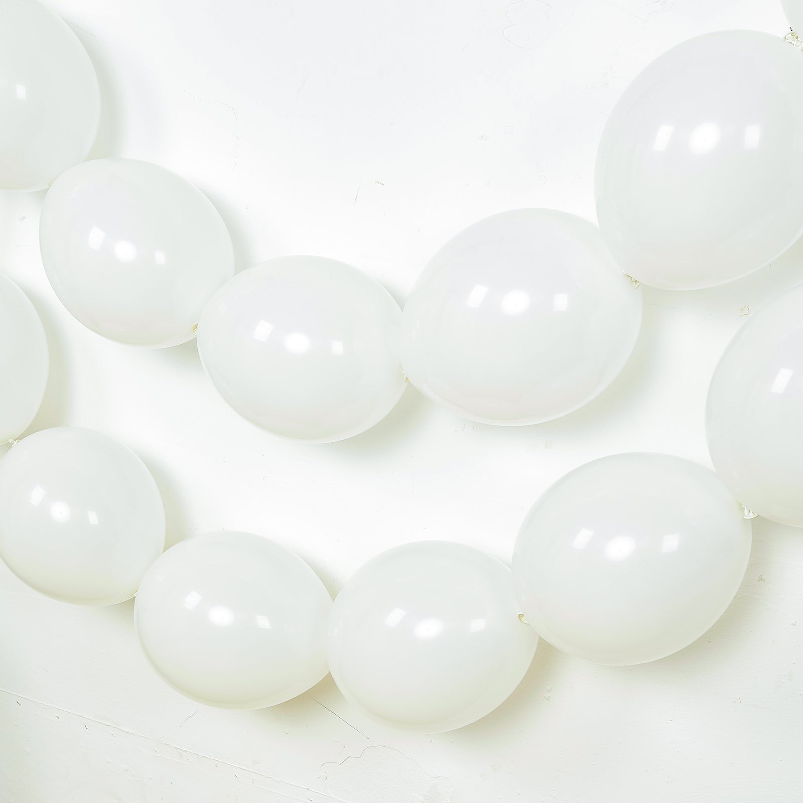 Matte pastel white biodegradable linking balloons for decor.