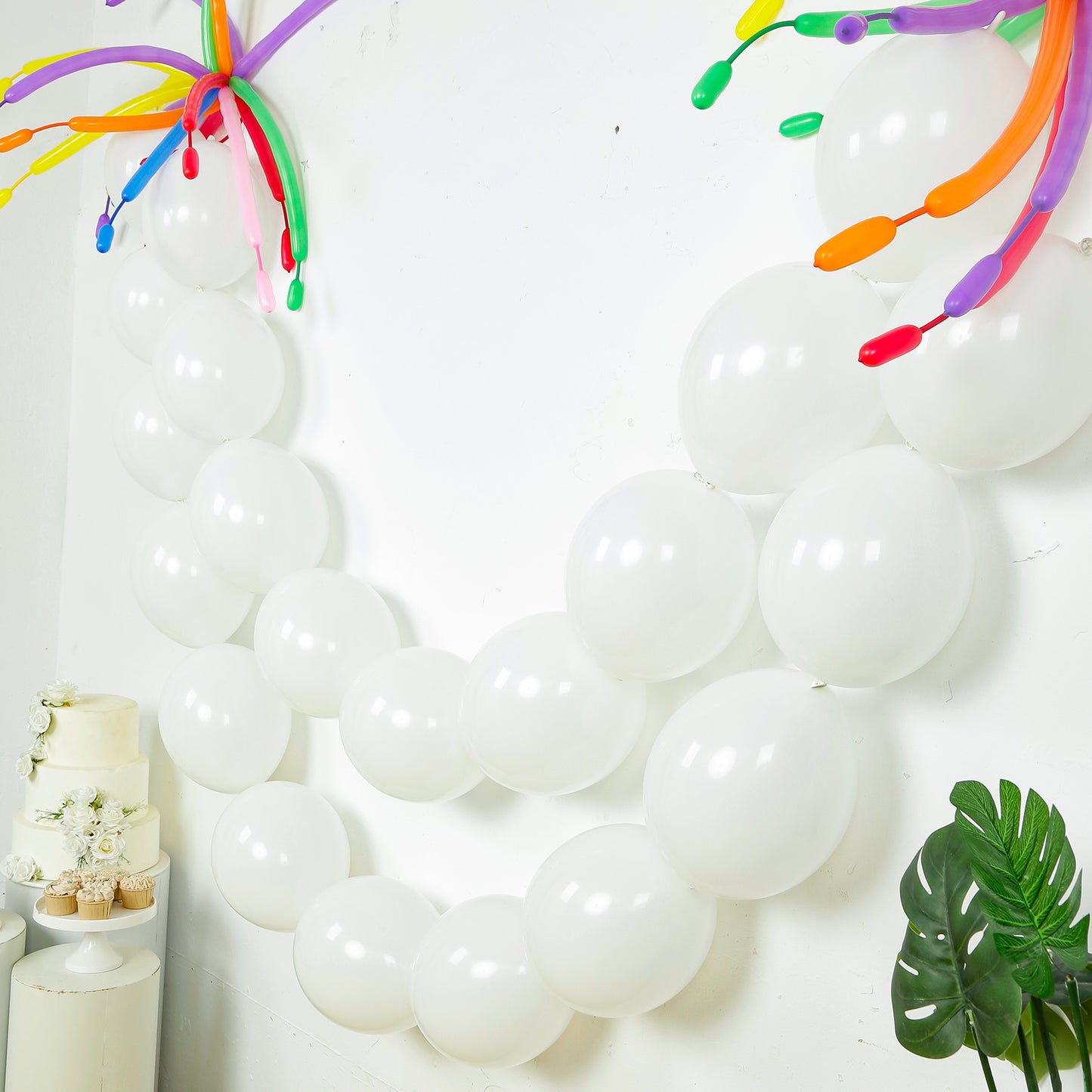 Matte pastel white biodegradable link balloons in a decorative arrangement.