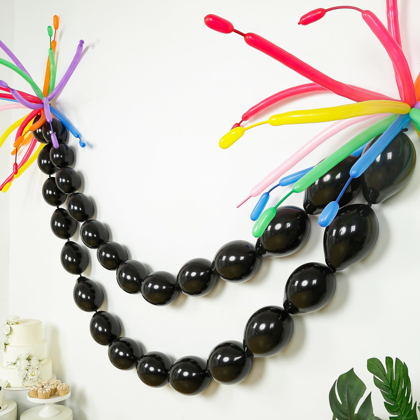 Matte pastel black biodegradable linking balloons in a decorative chain.