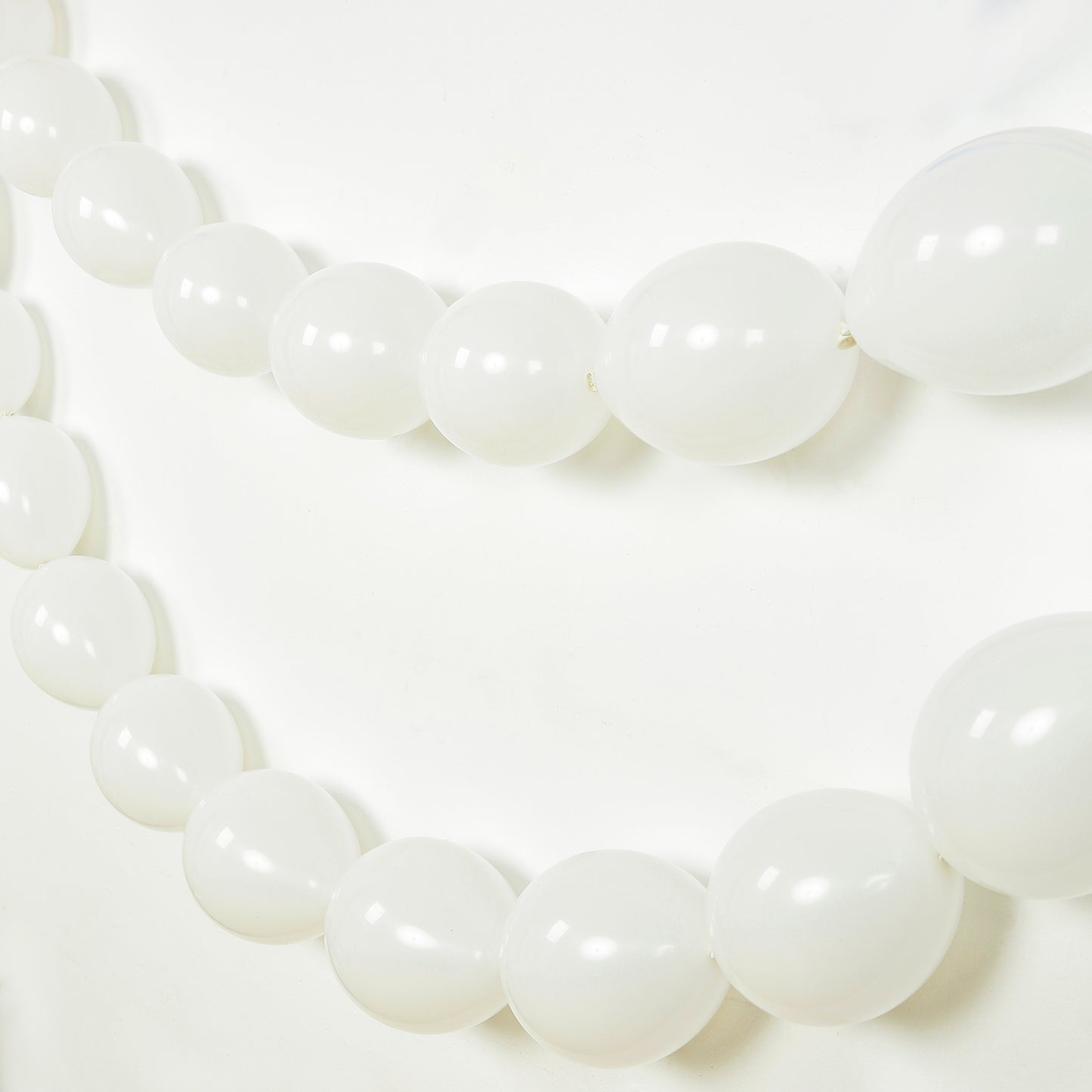 Matte pastel white biodegradable link balloons for decor and garlands.