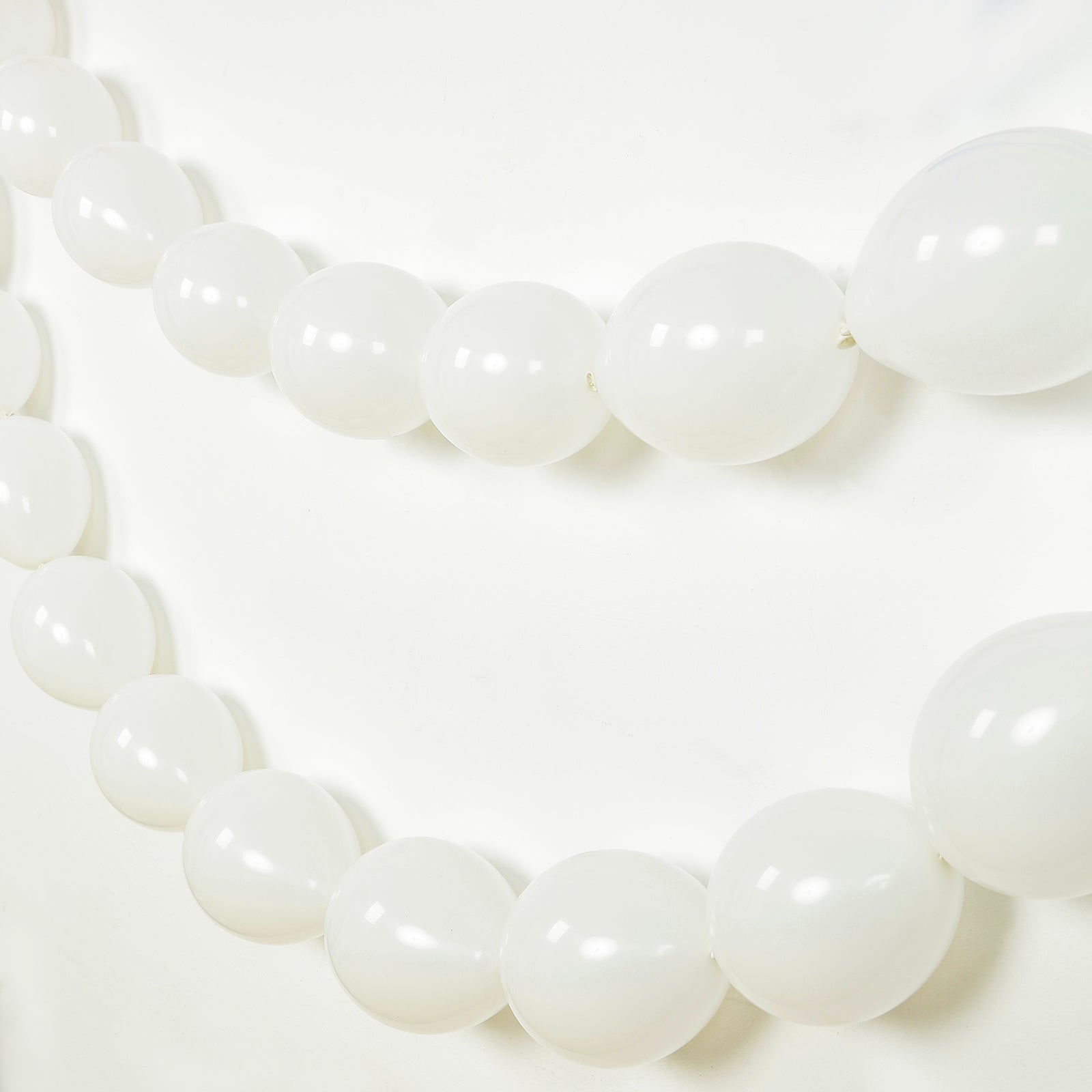Matte pastel white biodegradable link balloons for decor and garlands.