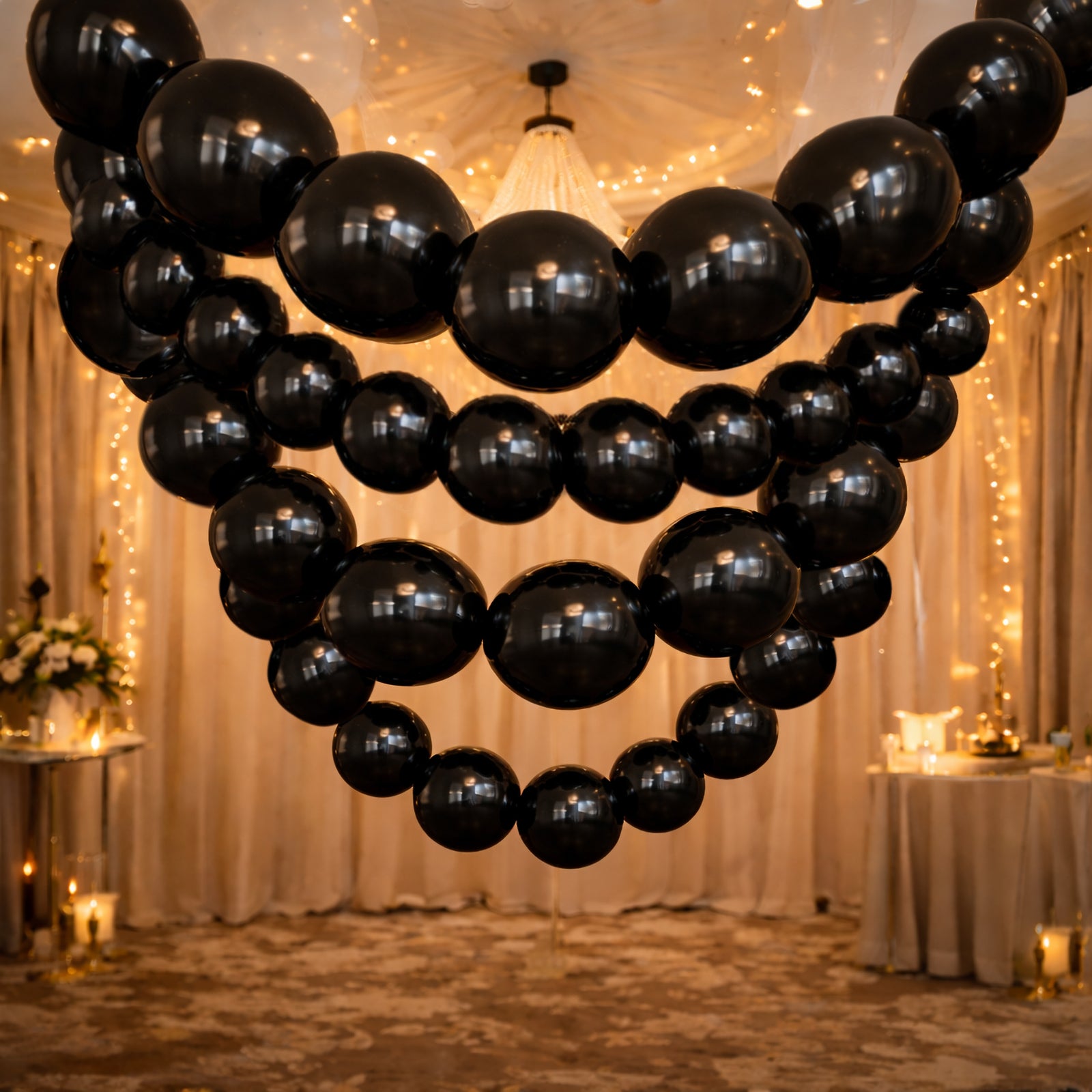 Matte pastel black biodegradable link balloons in a decorative display.