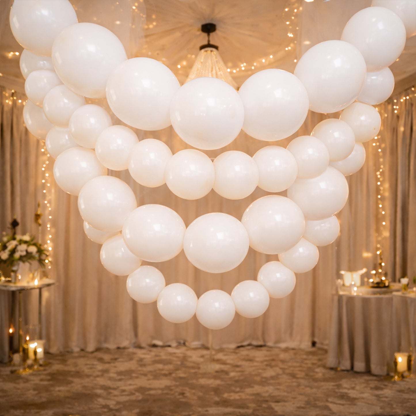 Matte pastel white biodegradable link balloons in a decorative garland.