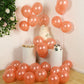 Rose gold biodegradable balloons arranged for a party setting.