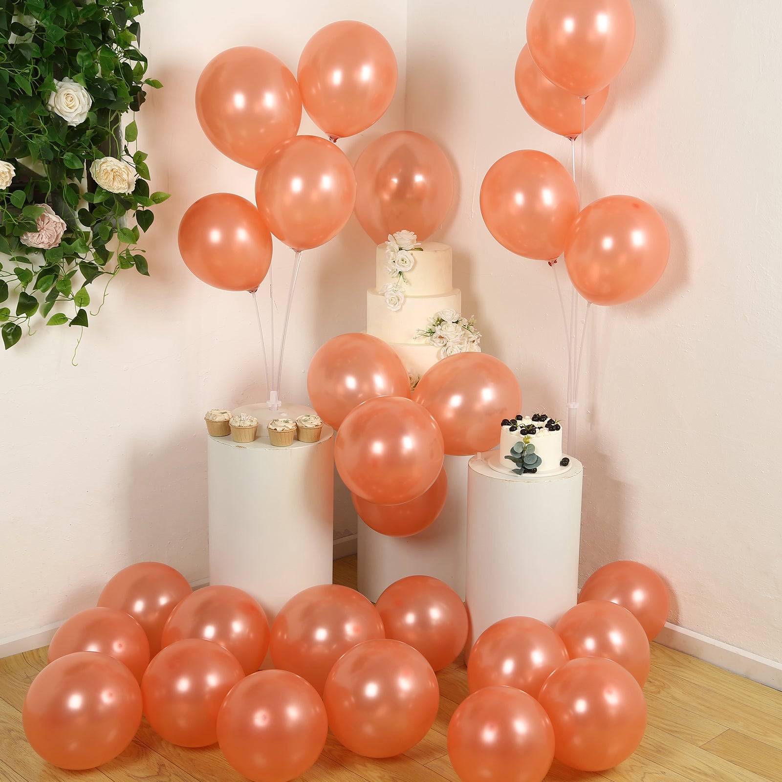 Rose gold biodegradable balloons arranged for a party setting.
