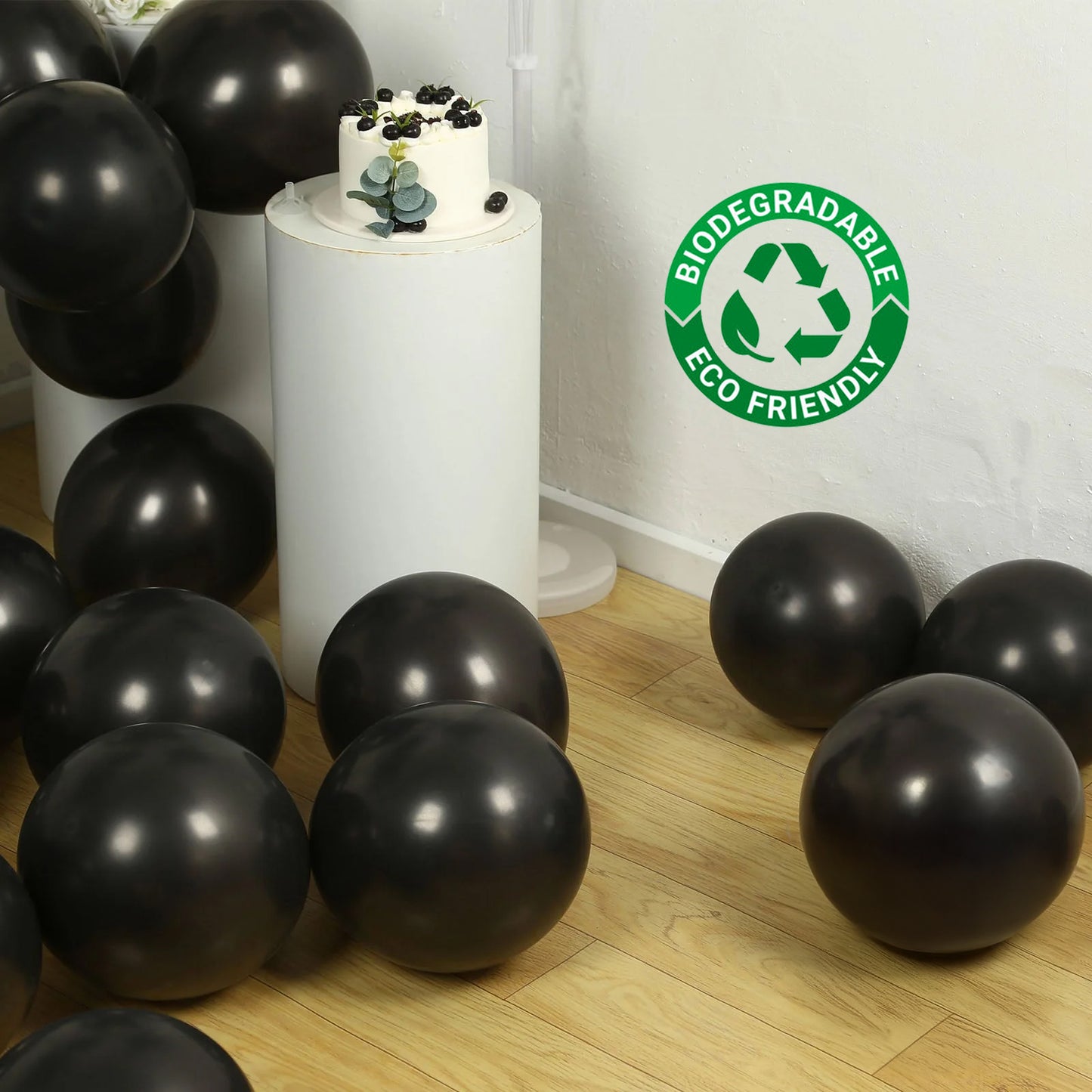 Black biodegradable helium balloons scattered on the floor.