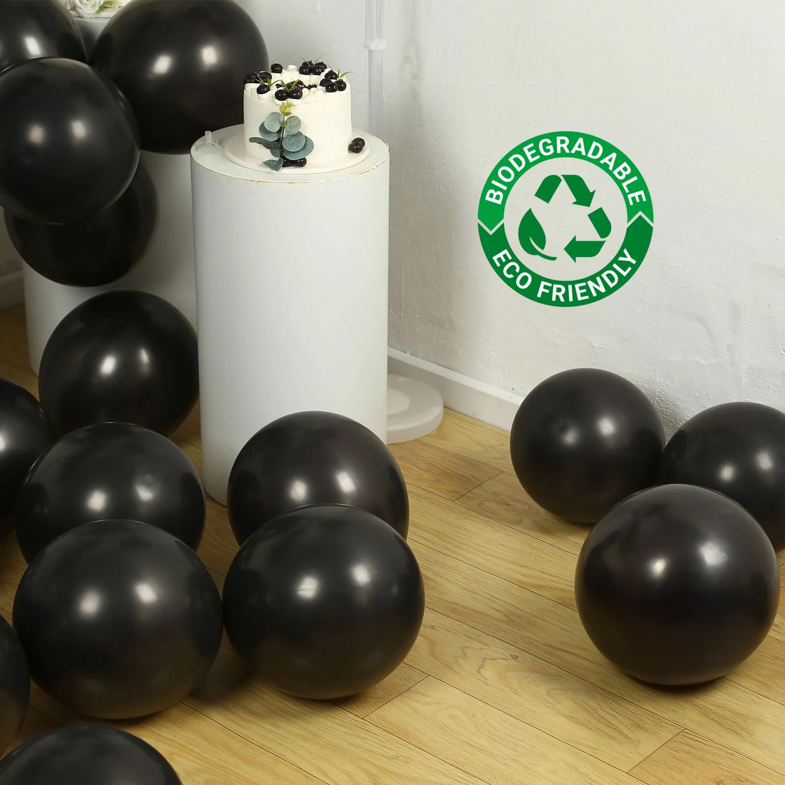 Black biodegradable helium balloons scattered on the floor.