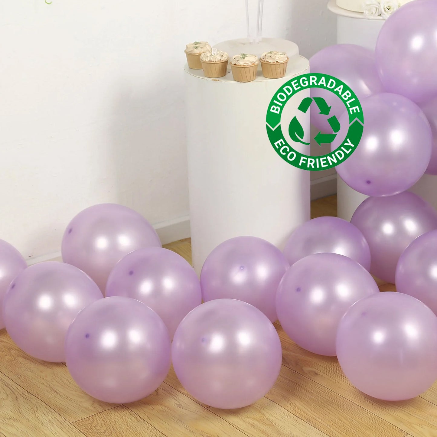 Lavender biodegradable balloons on a wooden floor with eco-friendly logo.