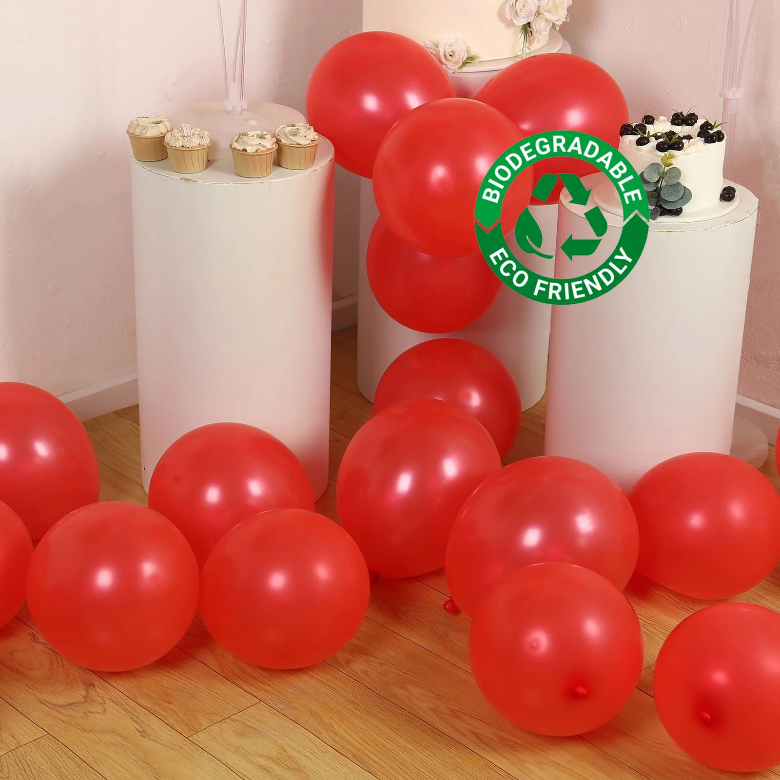 Red biodegradable balloons scattered on the floor.