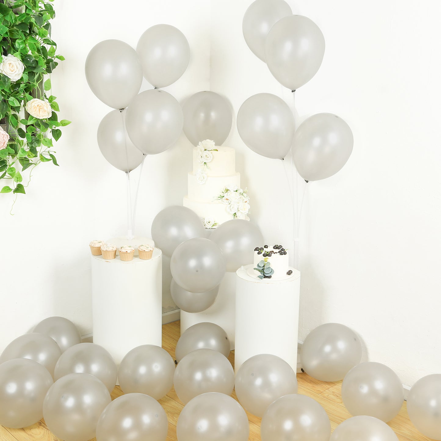 Silver biodegradable balloons arranged for a party setting.