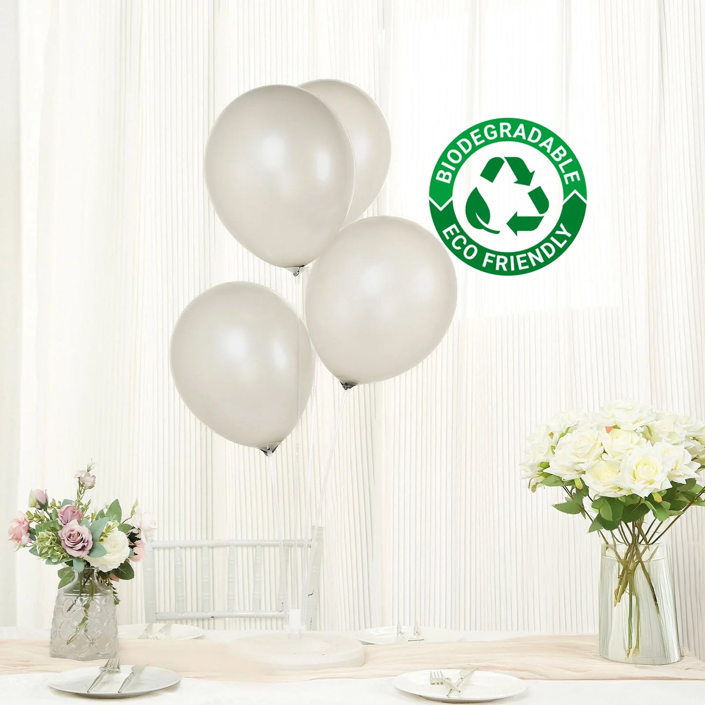 Silver biodegradable balloons displayed in a festive setting.