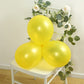 Yellow biodegradable balloons on a chair with greenery and flowers.