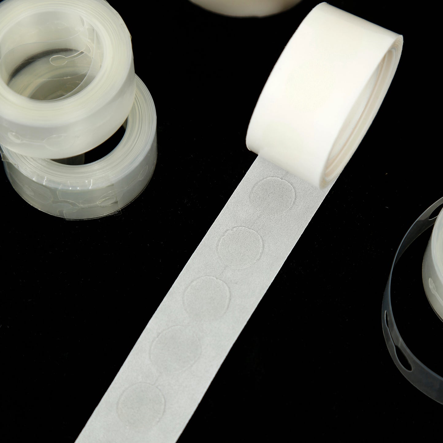 Clear balloon tape and glue dots for party decorations.