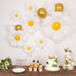 White daisy flower-shaped balloons with yellow centers for party decorations.