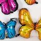 Assorted butterfly helium foil balloons in vibrant colors for fairy tale parties.