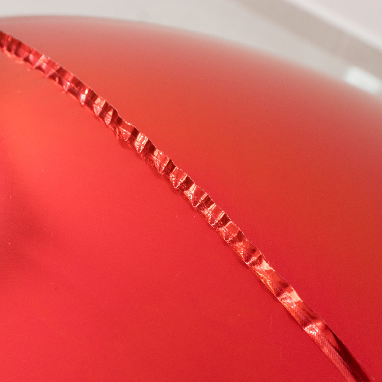 Metallic red sphere balloons for parties, helium or air-filled.
