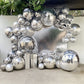 Metallic silver sphere balloons in a decorative arrangement for parties.