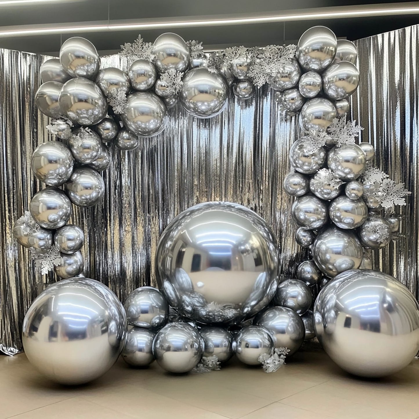 32" metallic silver sphere balloons arranged in a decorative display.