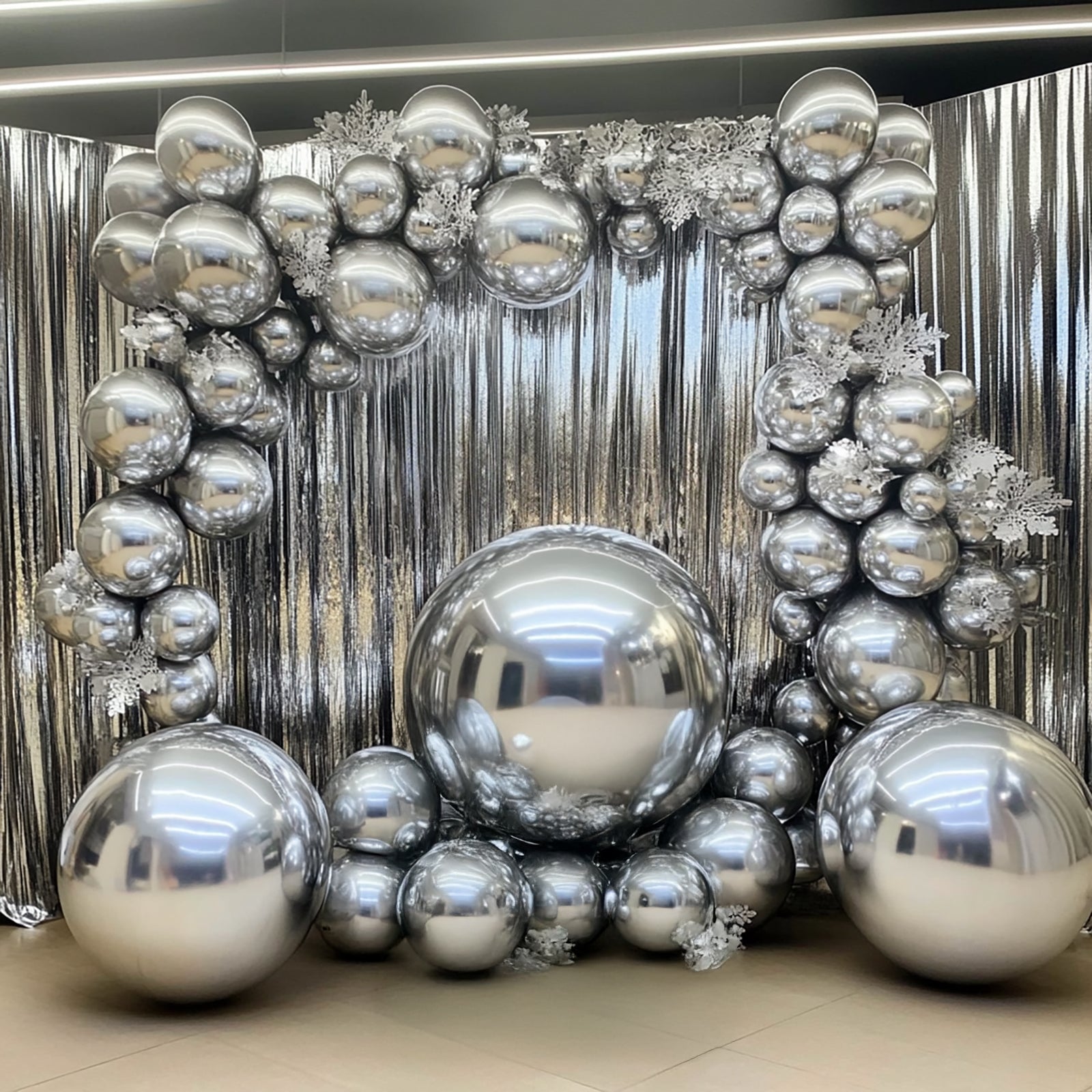 32" metallic silver sphere balloons arranged in a decorative display.